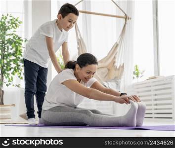 full shot woman kid working out