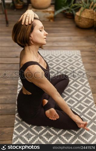 full shot woman meditating indoors