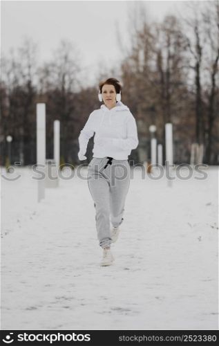 full shot woman running snow