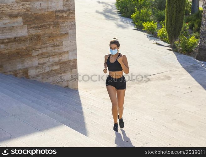 full shot woman running with mask