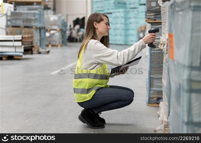 full shot woman scanning package