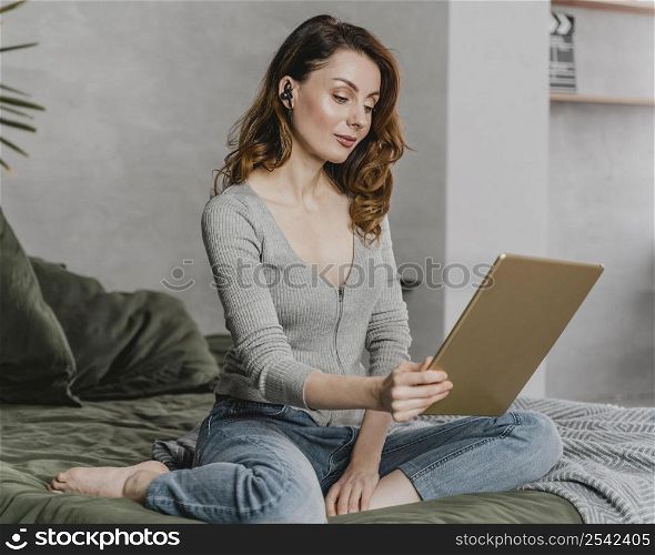 full shot woman streaming with tablet