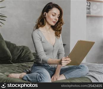 full shot woman streaming with tablet