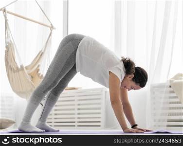 full shot woman stretching mat 2