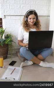 full shot woman working with laptop