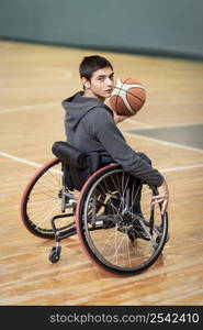 full shot young disabled man holding ball