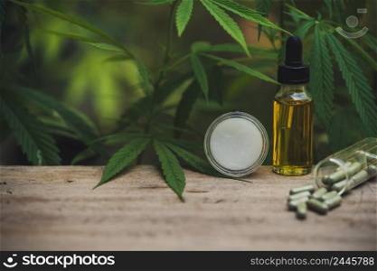 Full spectrum CBD and THC hemp oils, CBD pills and lotions on a chemically structured cannabis table.