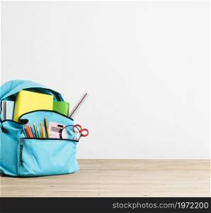 full stationery books blue school backpack. High resolution photo. full stationery books blue school backpack. High quality photo