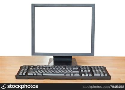 full view of black display with cut out screen and keyboard on wooden table isolated on white background