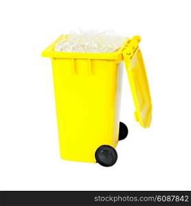 full yellow recycling bin with plastic isolated on white background