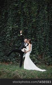 fun and crazy brides. happy gorgeous bride and stylish groom jumping and having fun, wedding couple, luxury wedding.. happy gorgeous bride and stylish groom jumping and having fun, wedding couple, luxury wedding. fun and crazy brides