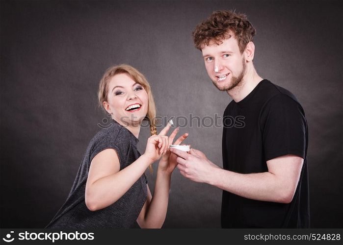 Fun and joy. Healthcare and protection. Funny smiling couple playing with moisturizer cream. Lovely woman with charming man.. Funny couple playing with cream.