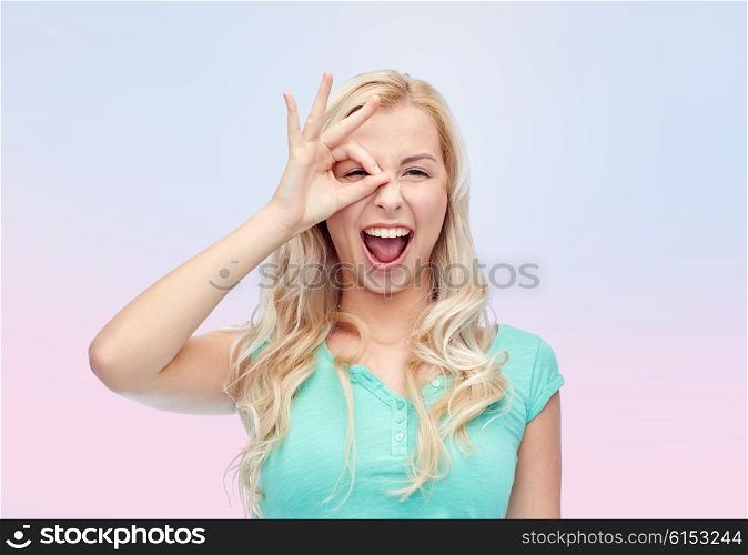 fun, emotions, expressions and people concept - smiling young woman or teenage girl making ok hand gesture over rose quartz and serenity gradient background