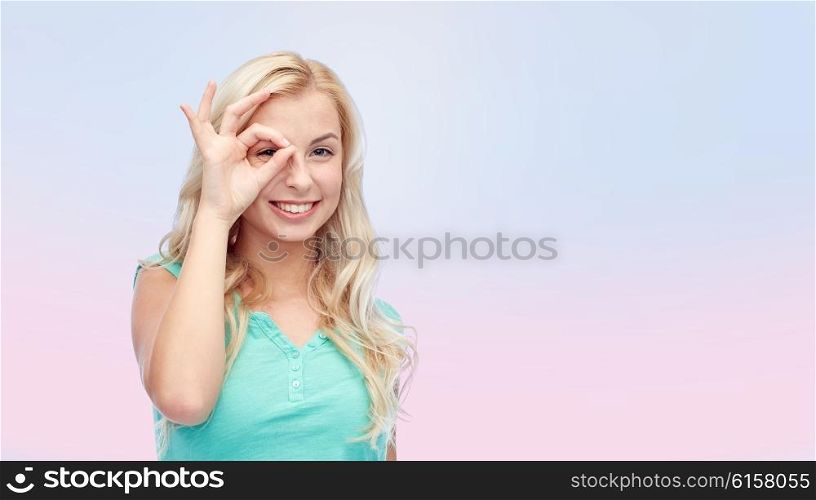 fun, emotions, expressions and people concept - smiling young woman or teenage girl making ok hand gesture over pink background