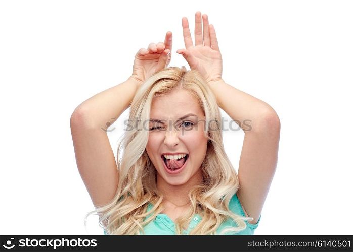 fun, expressions, easter and people concept - happy smiling young woman making bunny ears