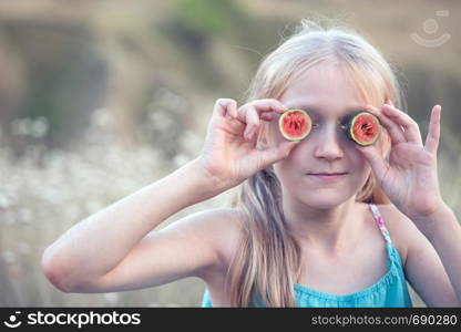 fun happy summer - beautiful blond little girl and watermelon