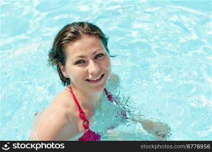 fun playful young girl bathes in pool