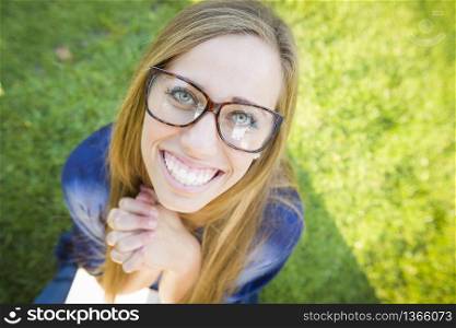 Fun Wide Angle Portrait of Pretty Young Woman at the Park.