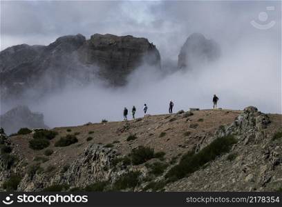 FUNCHAL,PORTUGAL-MARCH 24,unidentified people walking on the top of the pico arieiro mountains on march 24 2016 in Funchal,this mountain is one of the 2 highest on Madeira island. people on the pico arieiro on madeira island