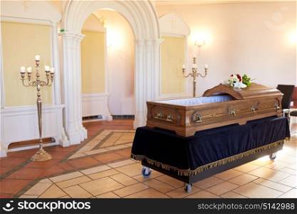 funeral and mourning concept - wooden coffin in christian orthodox church. wooden coffin at funeral in orthodox church