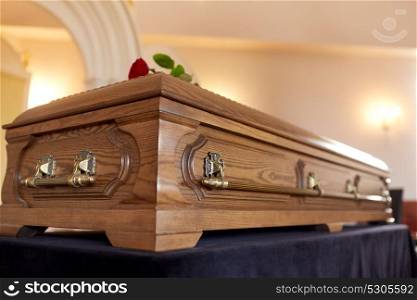 funeral and mourning concept - wooden coffin in church. coffin at funeral in church
