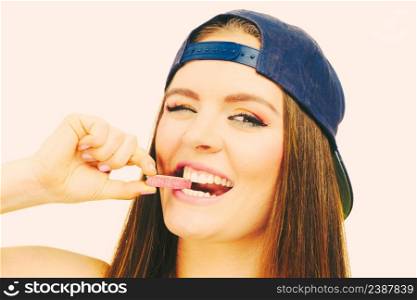 Funky people concept. Attractive girl chewing gum. Young woman has beautiful colourful make up. . Attractive girl chewing gum.