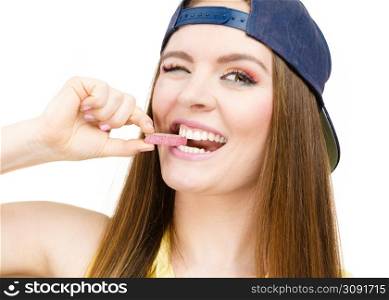 Funky people concept. Attractive girl chewing gum. Young woman has beautiful colourful make up. . Attractive girl chewing gum.