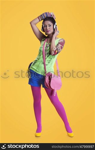 Funky young woman listening to music