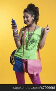 Funky young woman reading sms on mobile phone