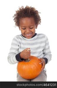 Funny African American boy with a pumpkin isolated on white background