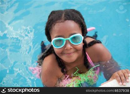 Funny afroamerican girl with goggles cooling off in the pool