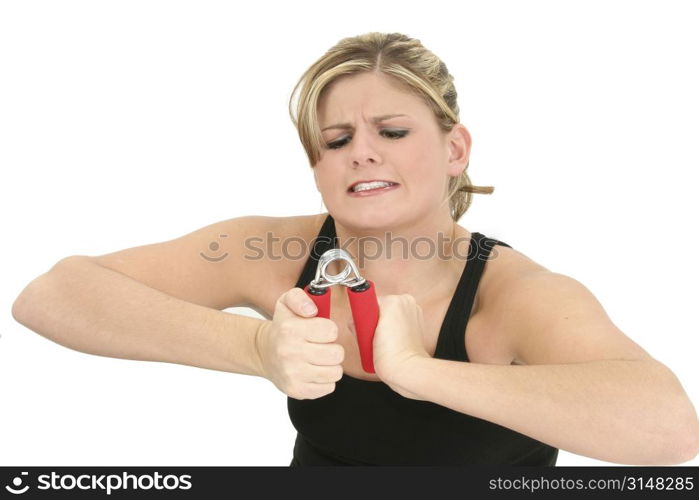 Funny and beautiful young woman struggling with hand grips.
