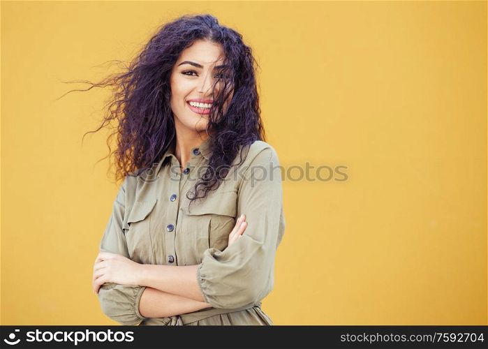Funny Arab Woman with curly hair in urban background. Young Arab Woman with curly hair outdoors