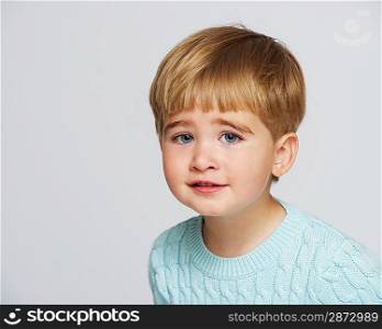 Funny baby boy in blue pullover portrait