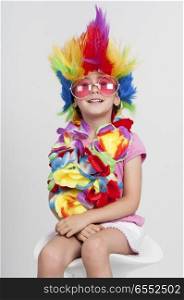 Funny beautiful party little girl in disguise with wig in many colors and pink round sunglasses