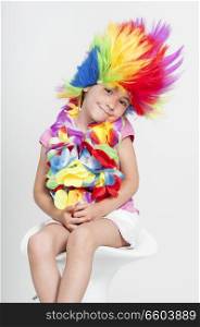 Funny beautiful party little girl in disguise with wig in many colors