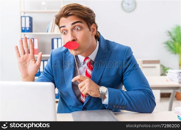 Funny bisinessman with fake lips in the office