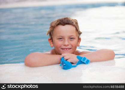 Funny blond boy cooling off in the pool