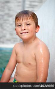 Funny blond boy cooling off in the pool