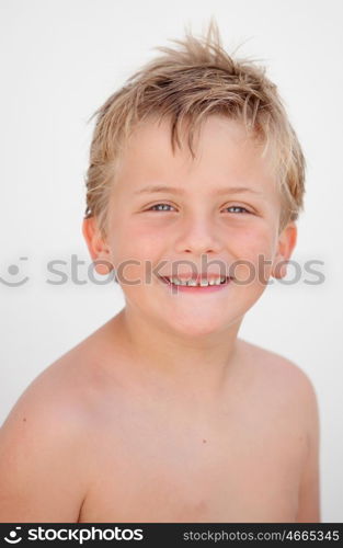 Funny blond boy looking at camera outside