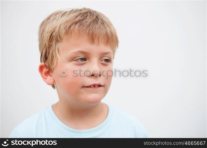 Funny blond boy looking at camera outside