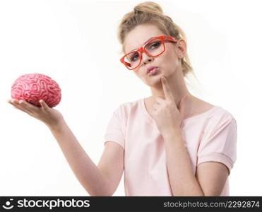 Funny blonde woman holding brain having something on mind, thinking of solution idea.. Woman holding brain having idea