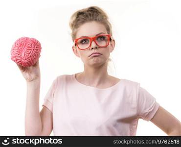 Funny blonde woman holding brain having something on mind, thinking of solution idea.. Woman holding brain having idea