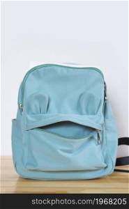 funny blue school bag in the form of a face . back to school concept. copy space.