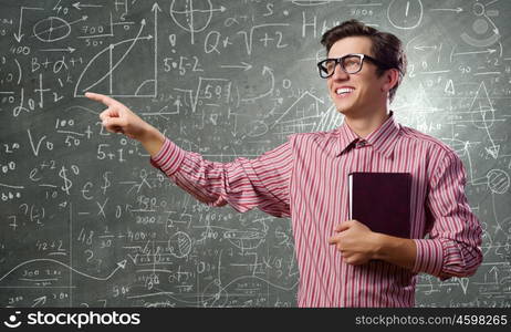 Funny botanist. Young funny man in glasses against chalkboard with sketches