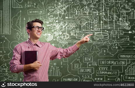 Funny botanist. Young funny man in glasses against chalkboard with sketches