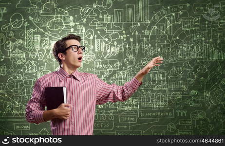 Funny botanist. Young funny man in glasses against chalkboard with sketches