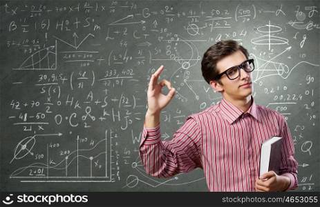 Funny botanist. Young funny man in glasses against chalkboard with sketches