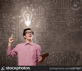 Funny botanist. Young funny man in glasses against chalkboard with sketches
