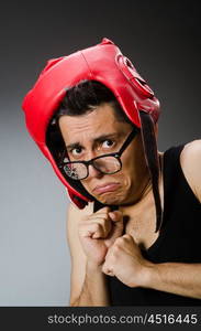 Funny boxer with red gloves against dark background